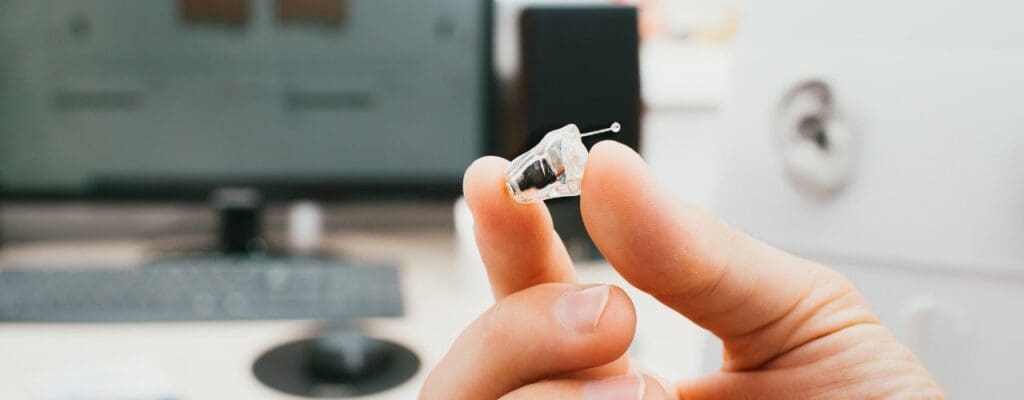 attachment-intraear-hearing-aid-closeup-in-a-male-hand-hearing-solution-a-man-a-picture-id1260059267-min