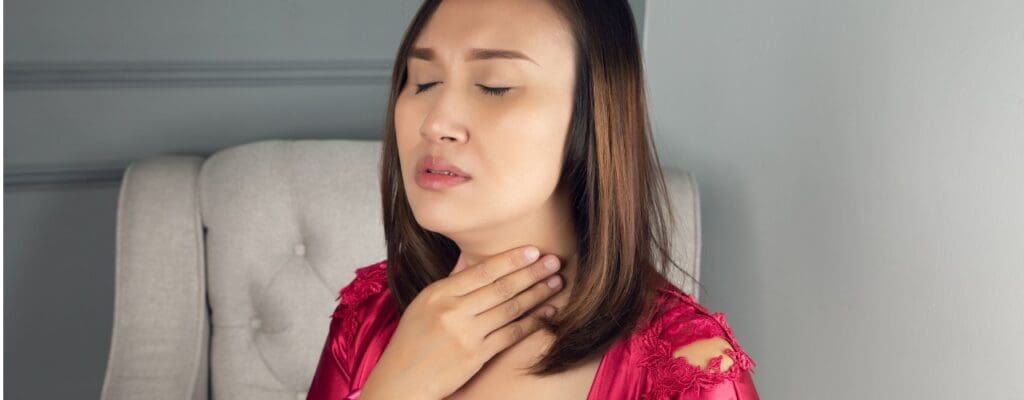 attachment-sore-throat-pain-symptoms-throat-infection-a-woman-wearing-a-satin-picture-id1282086329