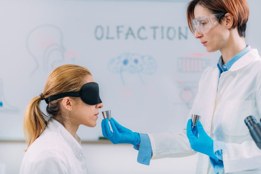 olfaction-blind-test-female-scientist-examining-selection-of-smell-samples-with-eye-cover