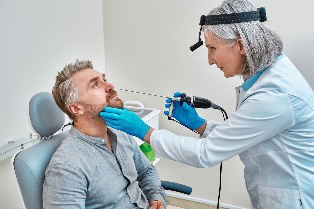 diagnostic-nasal-endoscopy-mature-ent-doctor-examining-male-patient-nose-using-video-ent-endoscope-at-medical-clinic