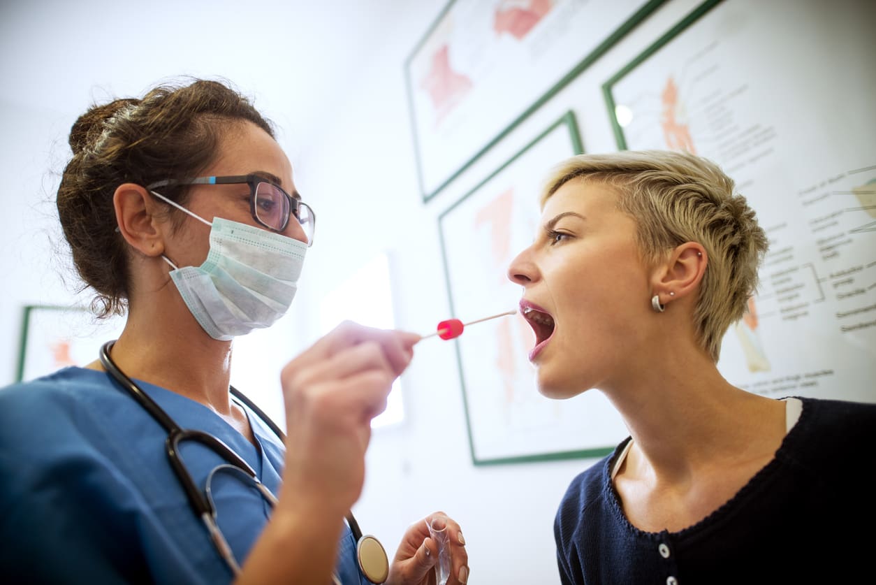 side-close-view-of-female-doctor-specialist-with-face-mask-holding-buccal-cotton-swab-and-test-tube-ready-to-collect-dna-from-the-cells-on-the-inside-of-a-woman-patient